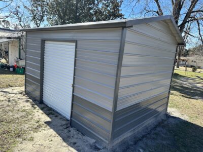 Enclosed metal structure with bay door for equipment storage