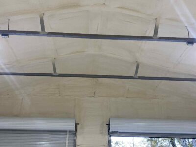 closed-cell and open cell spray foam insulation applied to interior metal building wall for energy efficiency