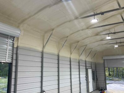 closed-cell and open cell spray foam insulation applied to interior metal building wall for energy efficiency