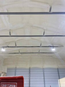 closed-cell and open cell spray foam insulation applied to interior metal building wall for energy efficiency