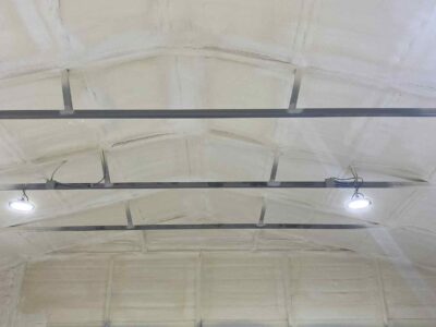 closed-cell and open cell spray foam insulation applied to interior metal building wall for energy efficiency