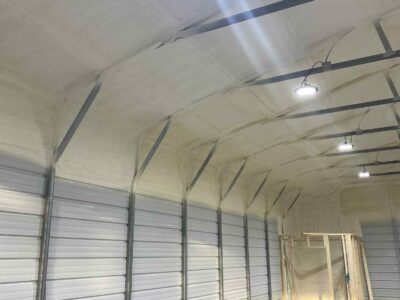 closed-cell and open cell spray foam insulation applied to interior metal building wall for energy efficiency